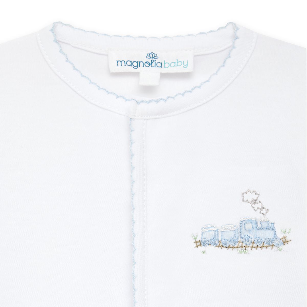 Light blue Magnolia Baby Choo Choo Train footie featuring train and locomotive design, soft cotton fabric, and snap closure.