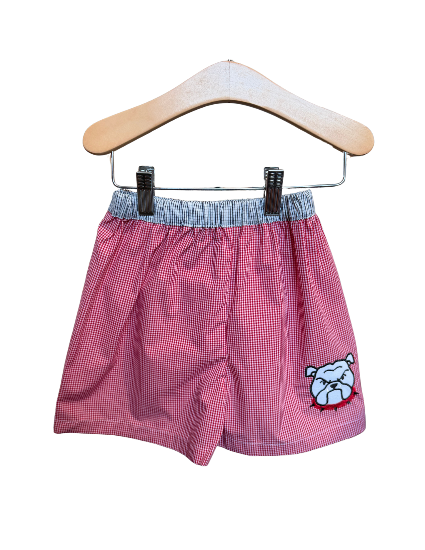 Red and white gingham fabric dog shorts featuring a bulldog design, by Remember Nguyen.