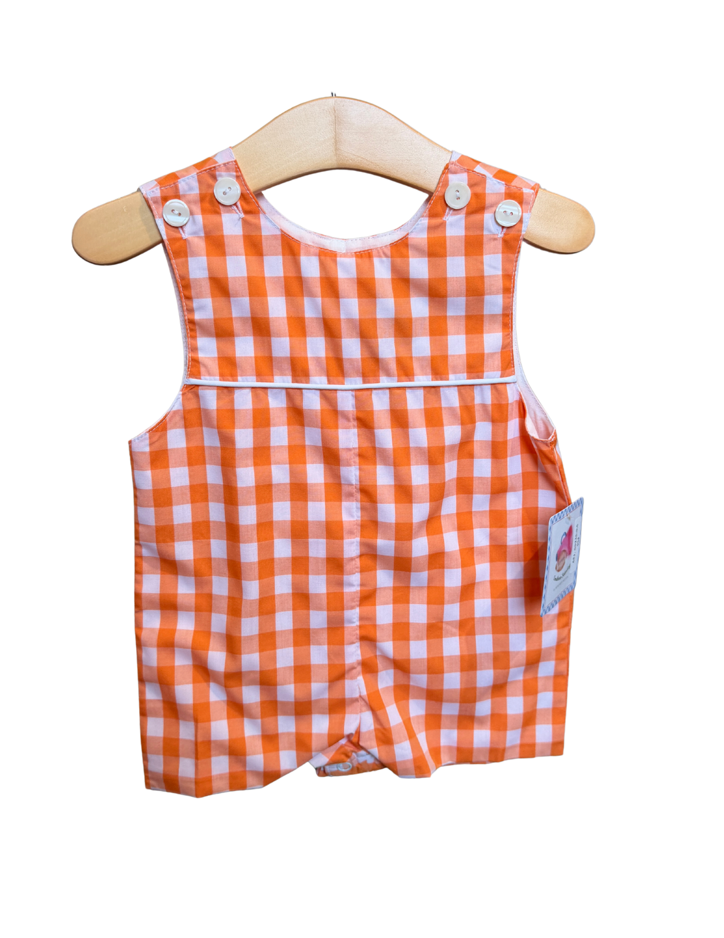 Orange and white gingham shortall for kids by Remember Nguyen, featuring adjustable straps and a front pocket.