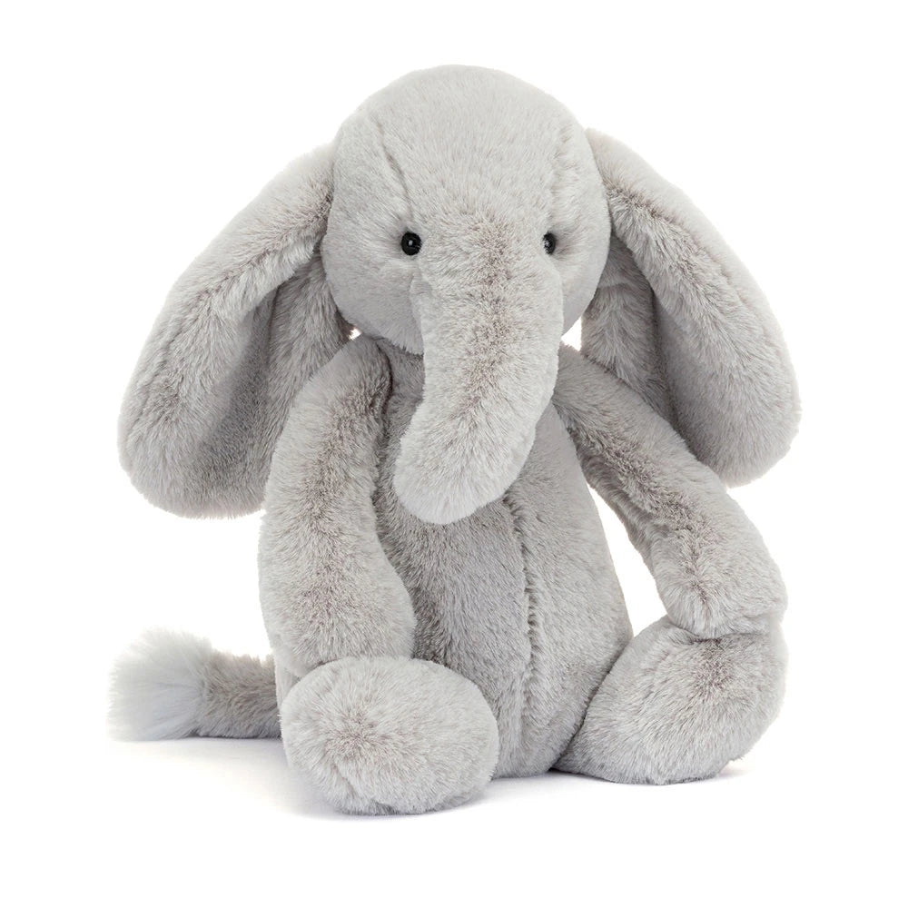 Soft Jellycat Bashful Luxe Elephant Thuddeus plush toy with fluffy grey fur and embroidered facial features.
