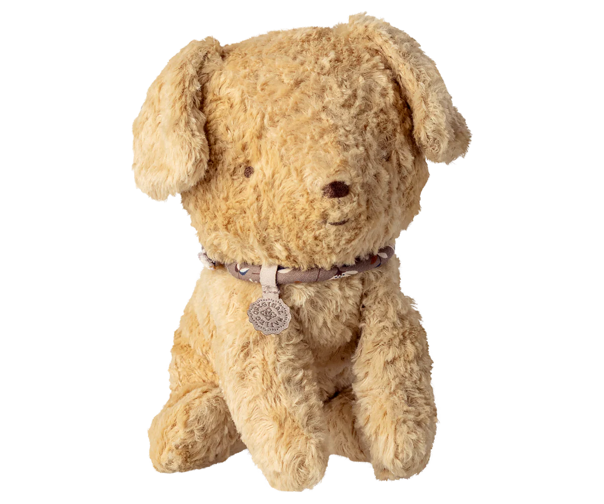 Small Maileg puppy in soft sand color, plush stuffed animal with detailed features, suitable for children's play and cuddling.