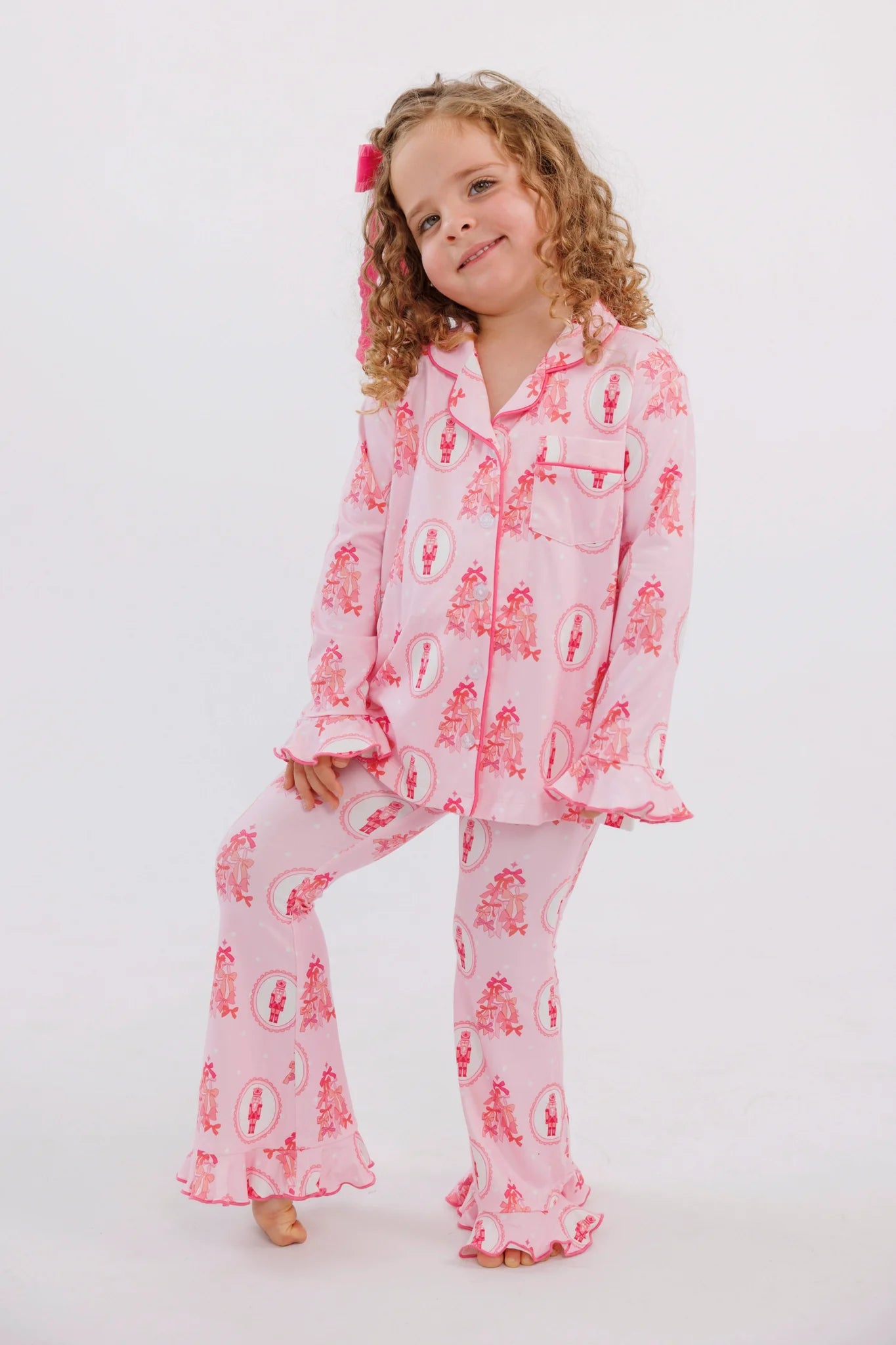 Pink long sleeve ruffle flare set for girls by In My Jammers, featuring bow details and a festive Nutcracker-inspired design.