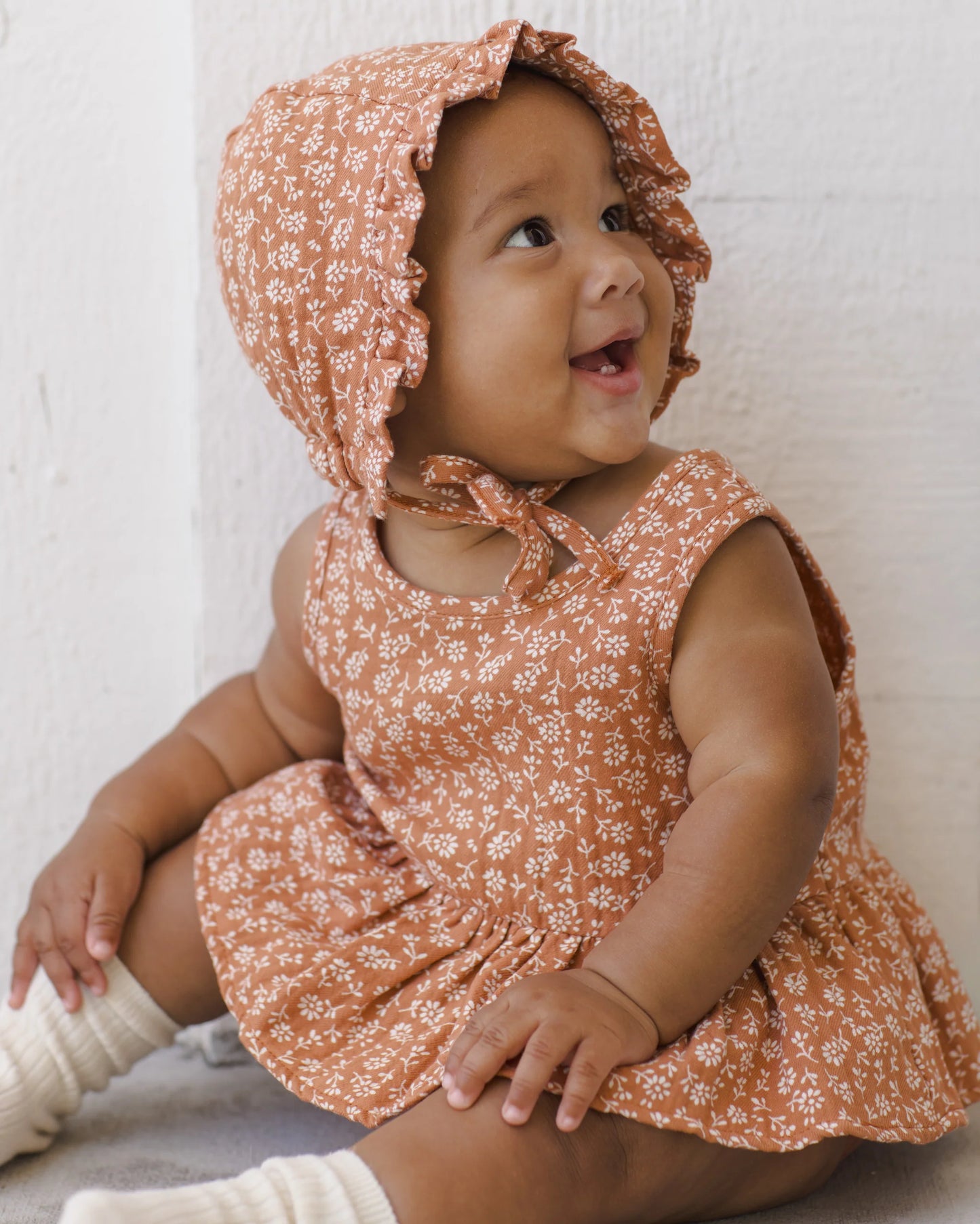 Poppy floral sleeveless peplum set for girls by Quincy Mae, featuring a colorful floral pattern and ruffled hem.