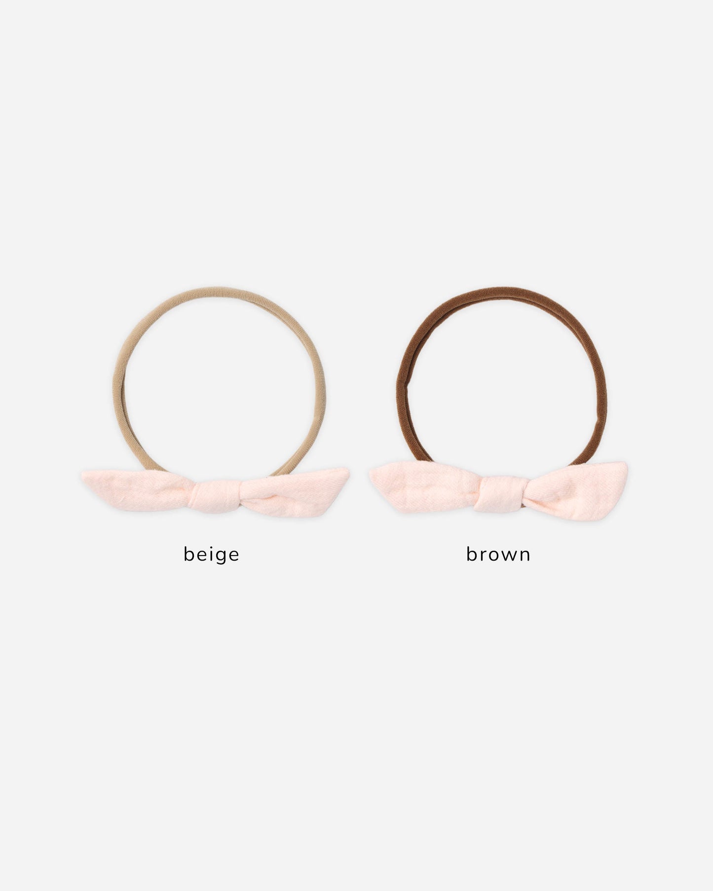 Quincy Mae Petal Little Knot Headband in soft pink fabric with a small knot detail for infants and toddlers.