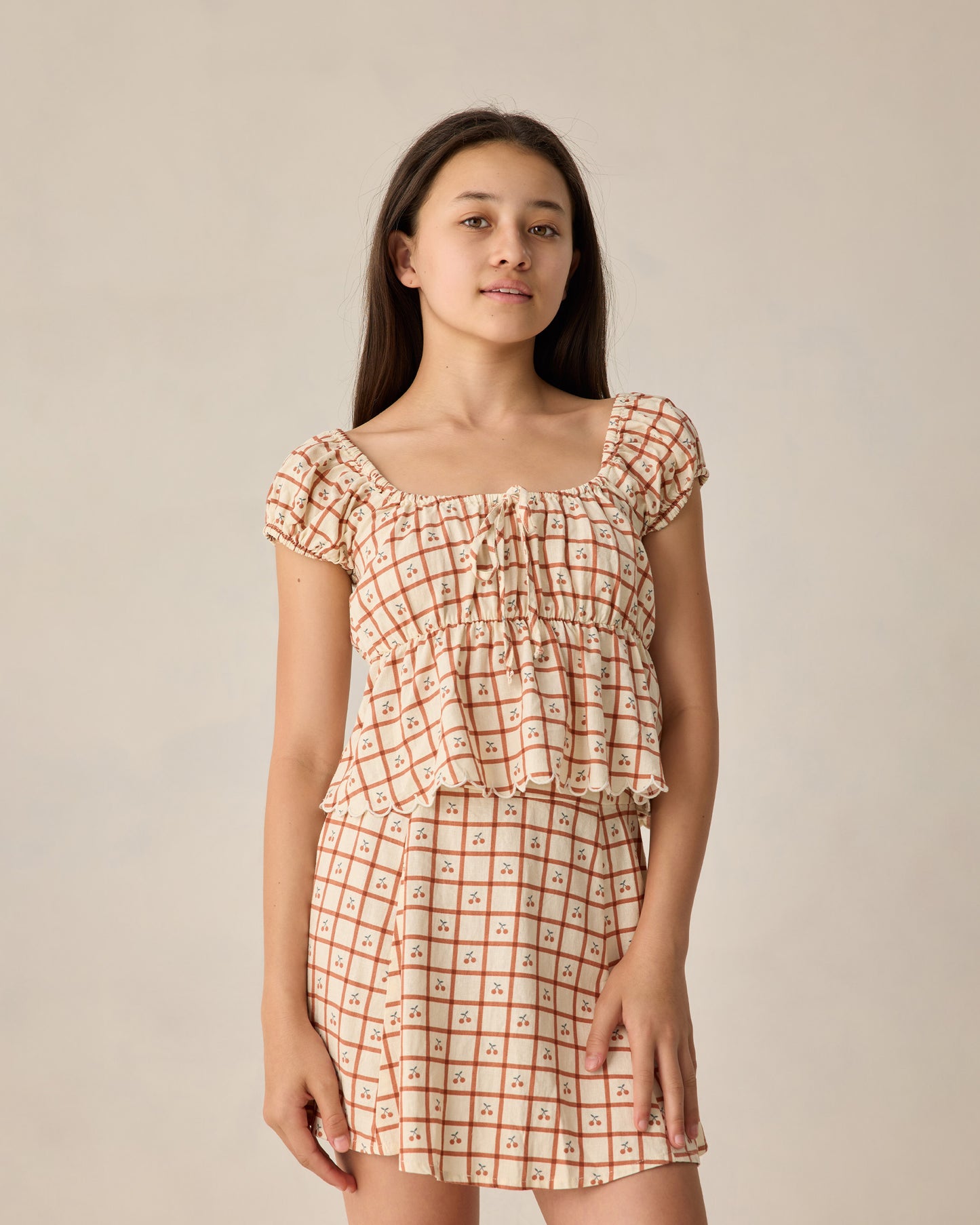 Teen Cherry Check Rylan Top by Rylee & Cru, featuring a stylish red and white checkered design, long sleeves, and a relaxed fit.