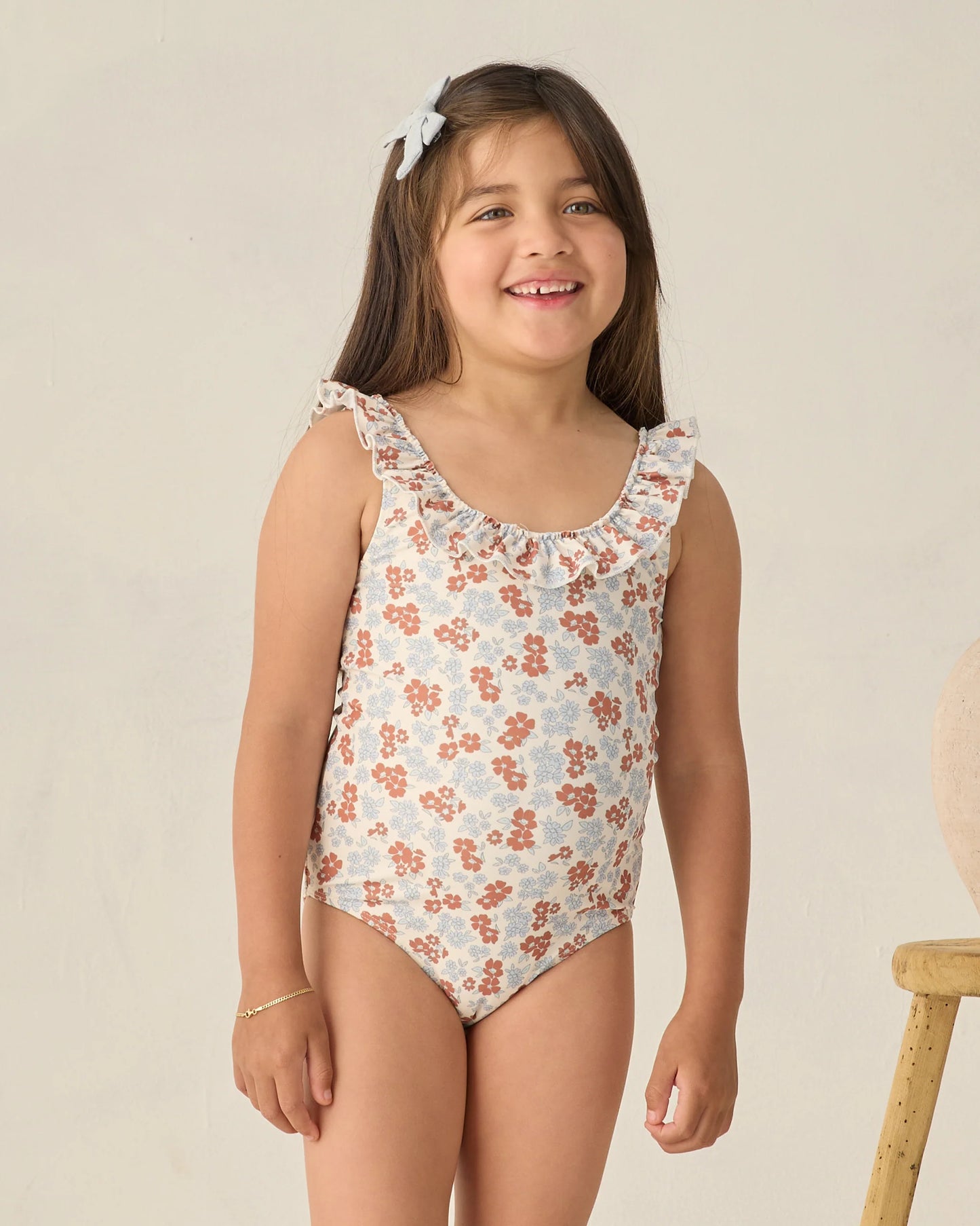 Rylee & Cru Americana Floral Giana one-piece swimsuit with colorful floral pattern and adjustable straps on a mannequin.
