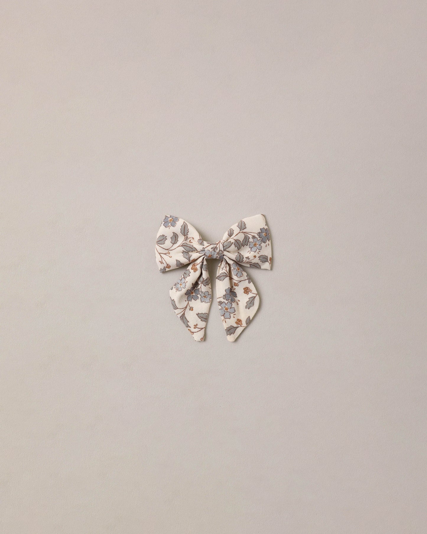 Blue Garden Norah Bow by Noralee, a stylish fabric hair accessory with a floral garden pattern and elegant bow design.