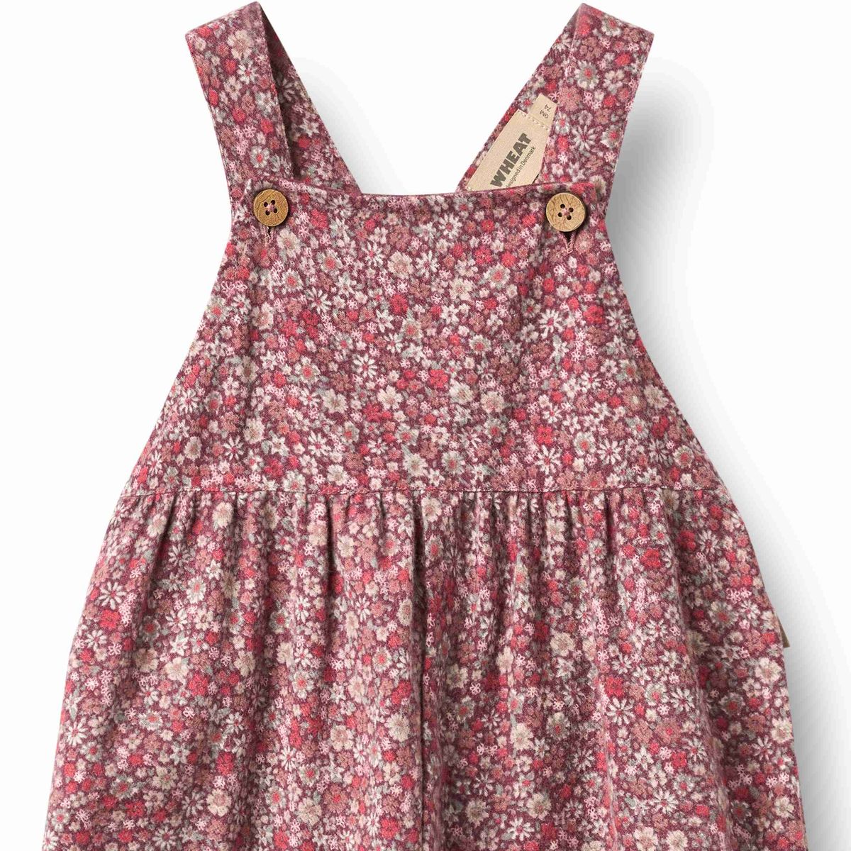 Wheat Grape Flowers Liz Overalls featuring a floral print with adjustable straps and a relaxed fit, displayed on a hanger.