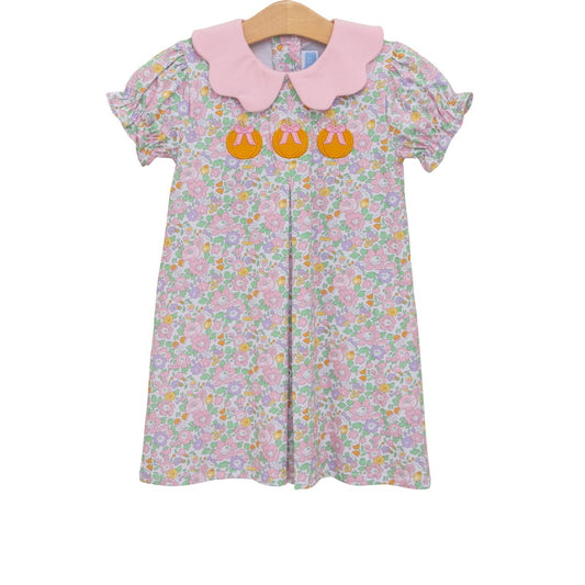 Pumpkin floral dress by Trotter Street featuring a vibrant floral pattern and flowing fabric, ideal for fall or casual wear.