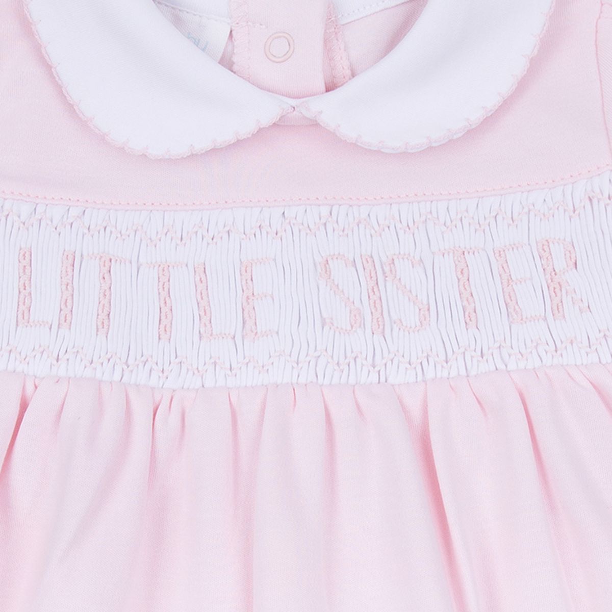 Pink Little Sister smocked footie by Magnolia Baby, soft cotton one-piece with delicate smocking and adorable design.