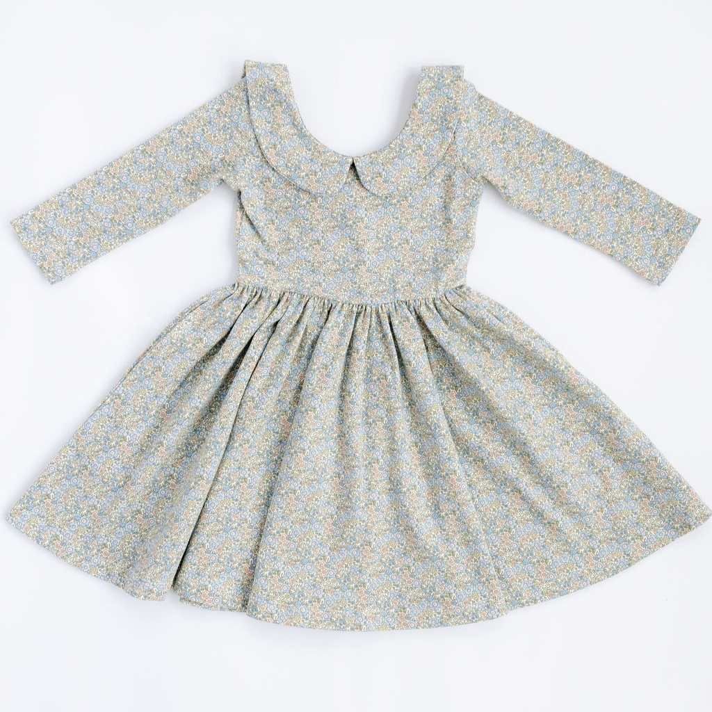 Blue watercolor floral twirl dress with 3/4 sleeves and a collar by Good Apples, shown on a model.
