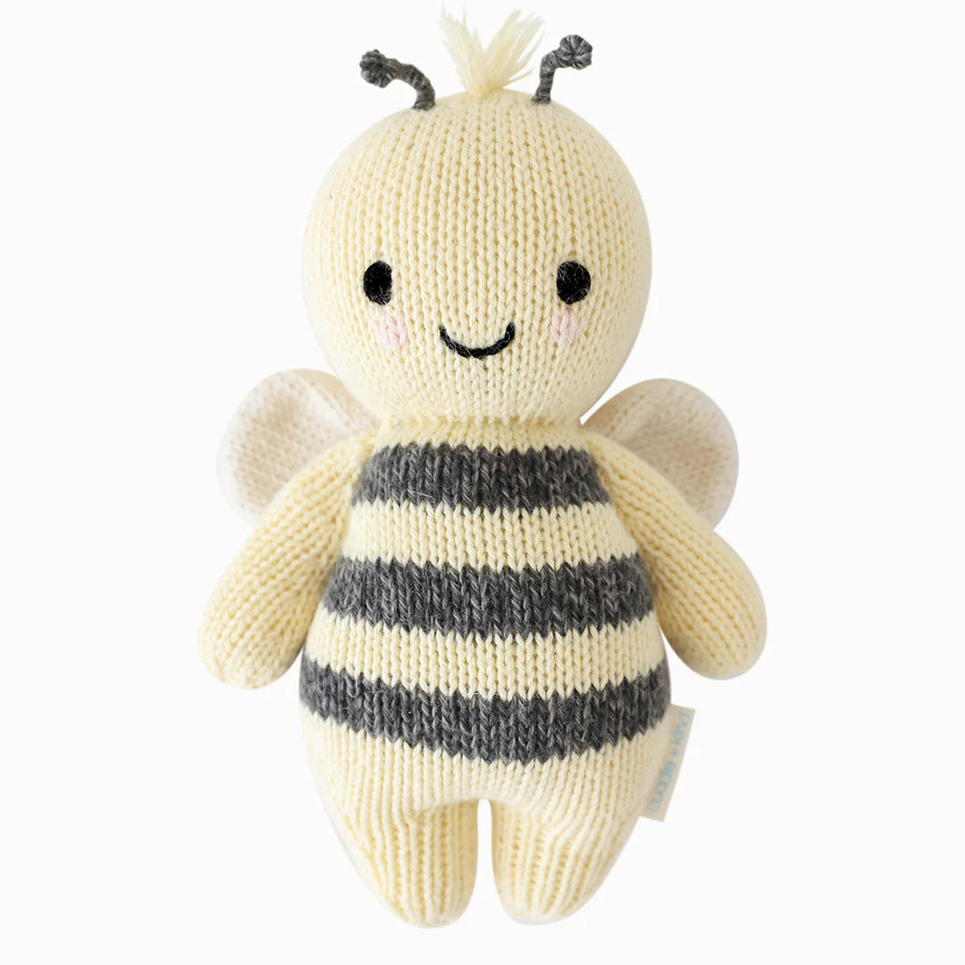 Soft plush Baby Bee toy by cuddle + kind with detailed yellow and black bee design, perfect for cuddling and play.