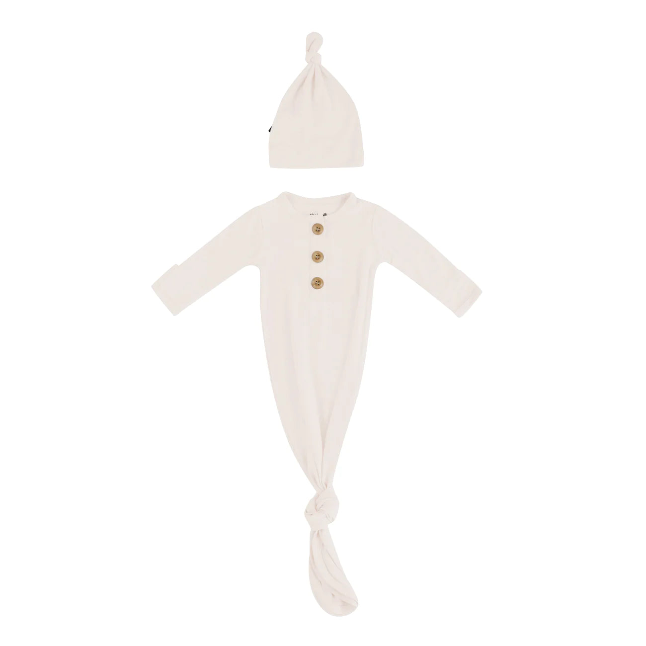 Kyte Baby knotted baby gown with matching hat in oat color, soft and cozy for infants, made from gentle fabric.