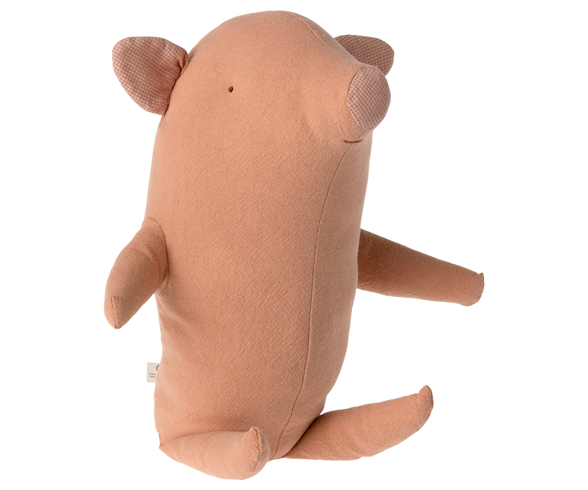 Medium Truffle Pig by Maileg, a soft plush toy with a charming design and floppy ears, lying on a textured surface.