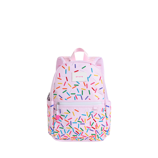 State Bags Sprinkles Kane Mini Backpack featuring colorful sprinkle pattern, compact design, and adjustable straps.