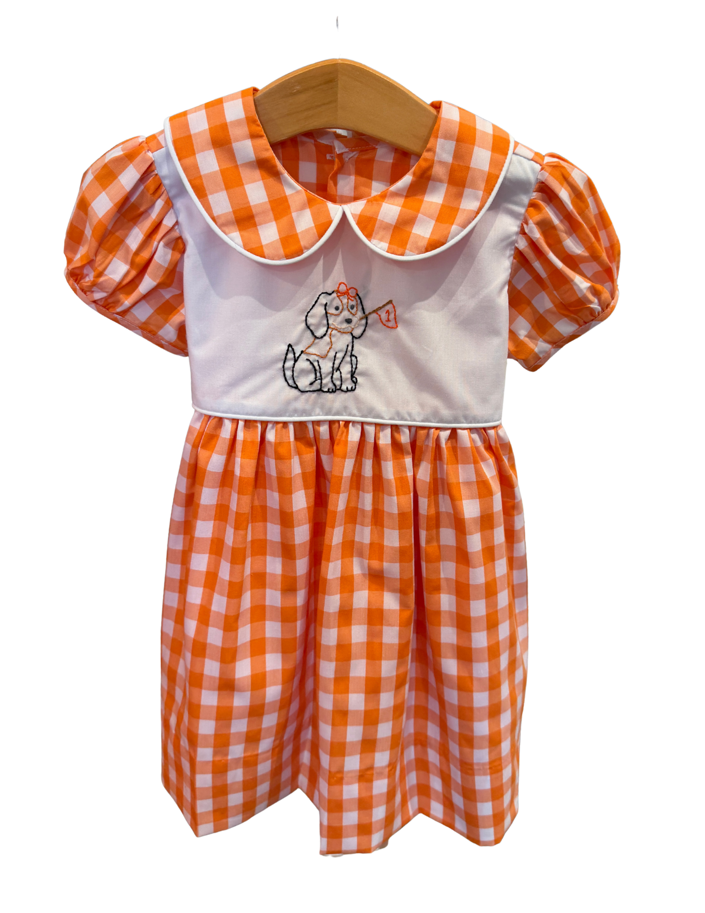 Orange and white gingham dress with embroidered Smokey Girl design by Remember Nguyen, featuring a classic, charming style.