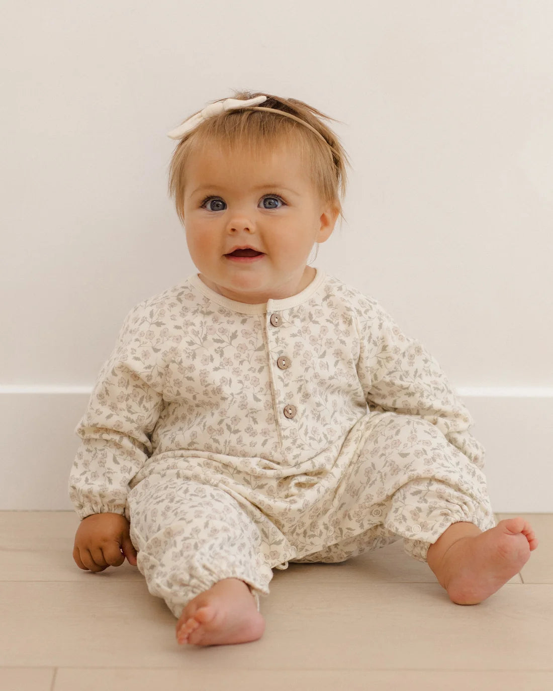 Quincy Mae Floret Henley Bubble Jumpsuit for babies, featuring a soft fabric with a buttoned henley neckline and bubble style design.