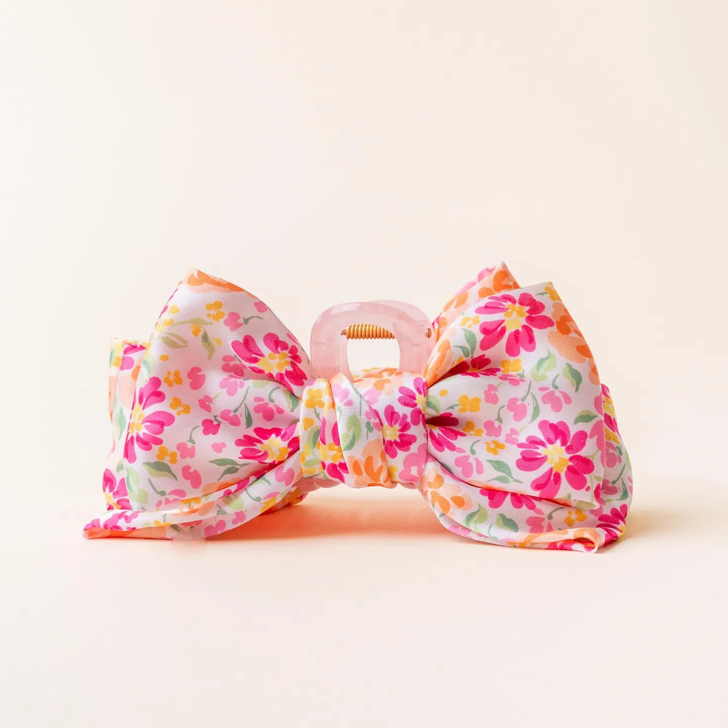The Darling Effect satin bow claw clip in Secret Garden Pink with a large bow design on a hair accessory.