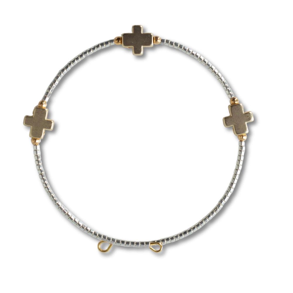 Set of shiny gold Faithful Bangles by Lenny & Eva, stacked together with smooth, reflective surfaces on a neutral background.