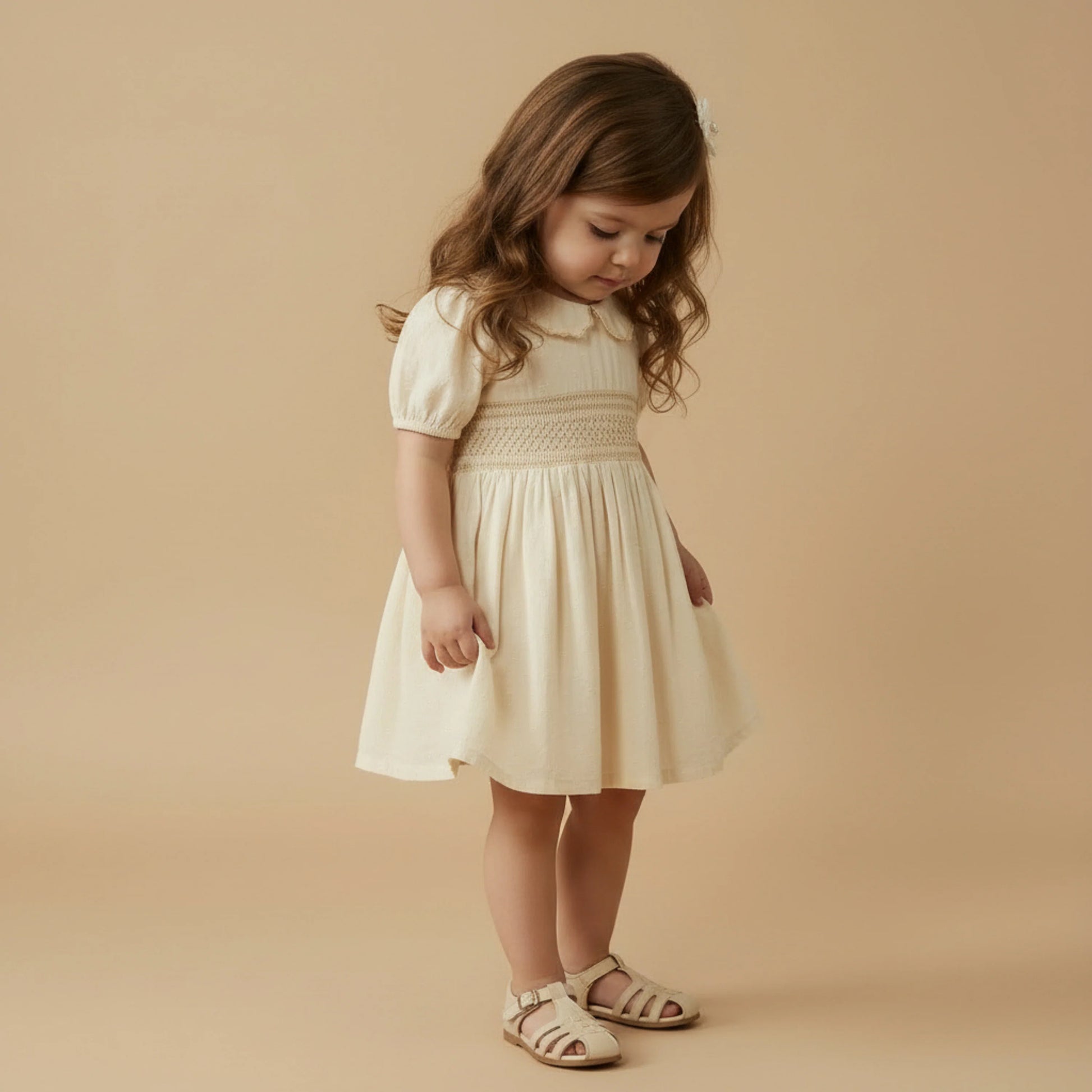 Butter yellow organic cotton smocked collar dress from MakeMake, featuring a ruffled collar and sleeveless design.