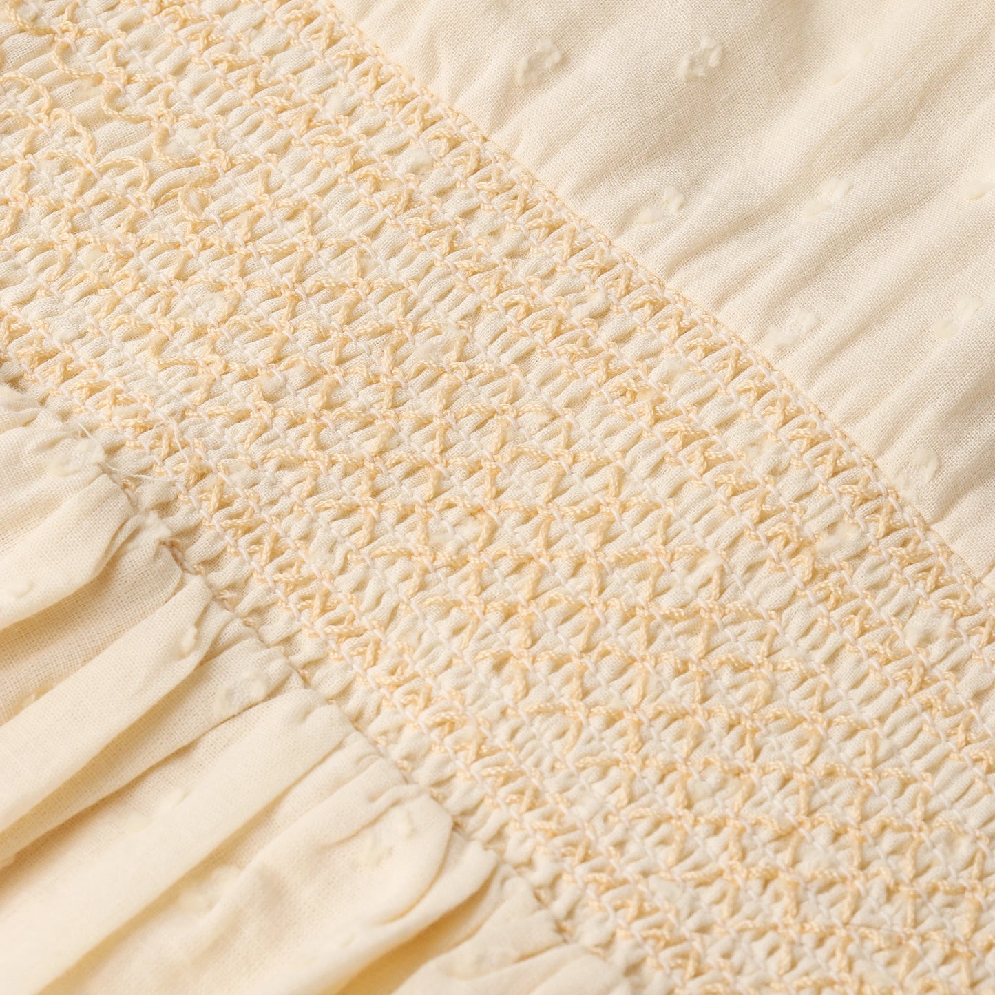 Butter yellow organic smocked collar dress by MakeMake, featuring a flowy design with a smocked neckline and puff sleeves.