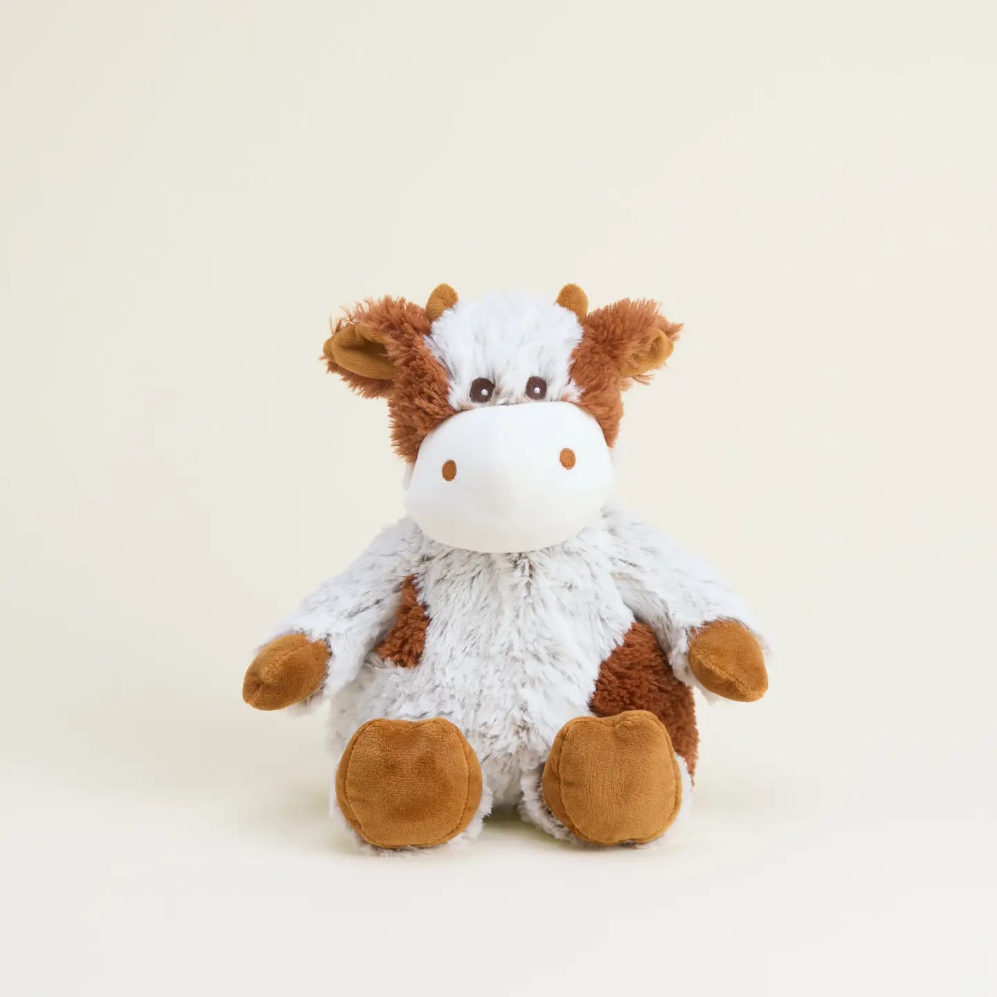 Warmies Cinnamon Latte Cow plush warmie with soft fabric and embroidered cow design, perfect for cozy comfort and relaxation.