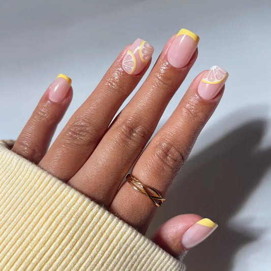 Glamnetic Limonata press-on nails with yellow French tips, short squoval shape, and a vibrant, fresh lemon-inspired design.