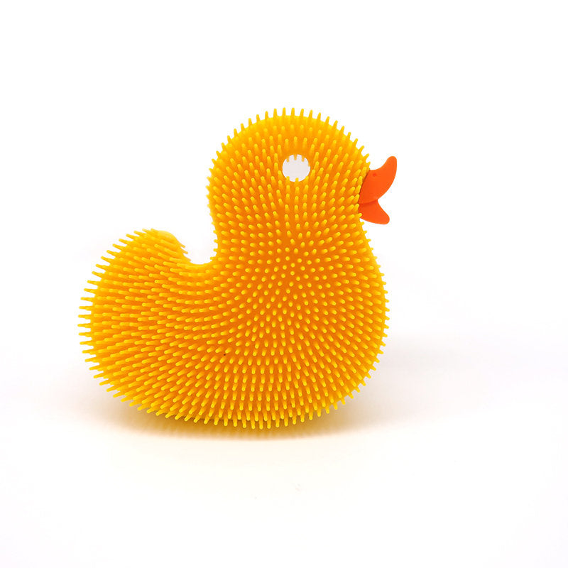 Squigee Duck silicone body scrub toy for babies, soft and colorful bath toy from New People, designed for gentle cleaning and play.