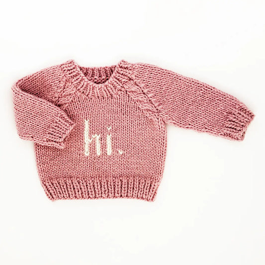 Huggalugs rosy crew neck sweater for babies and toddlers, soft knit with a cozy fit and pink color, suitable for little ones.