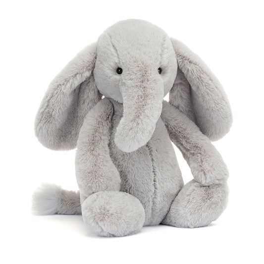 Soft Jellycat Bashful Luxe Elephant Thuddeus plush toy with fluffy grey fur and embroidered facial features.