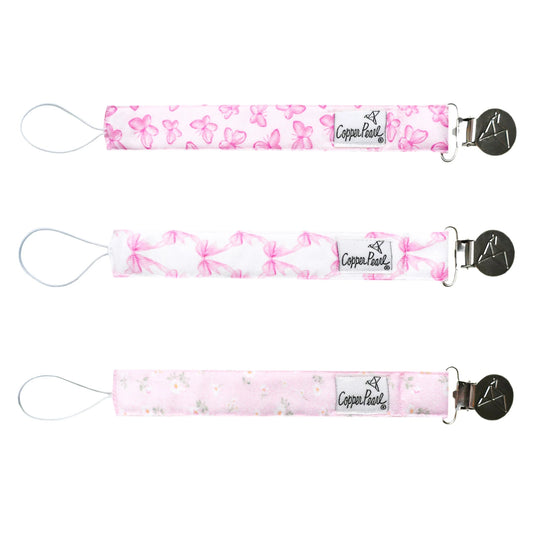 Copper Pearl Bow My Gosh binky clips featuring adorable bow designs on soft fabric clips for baby pacifiers.