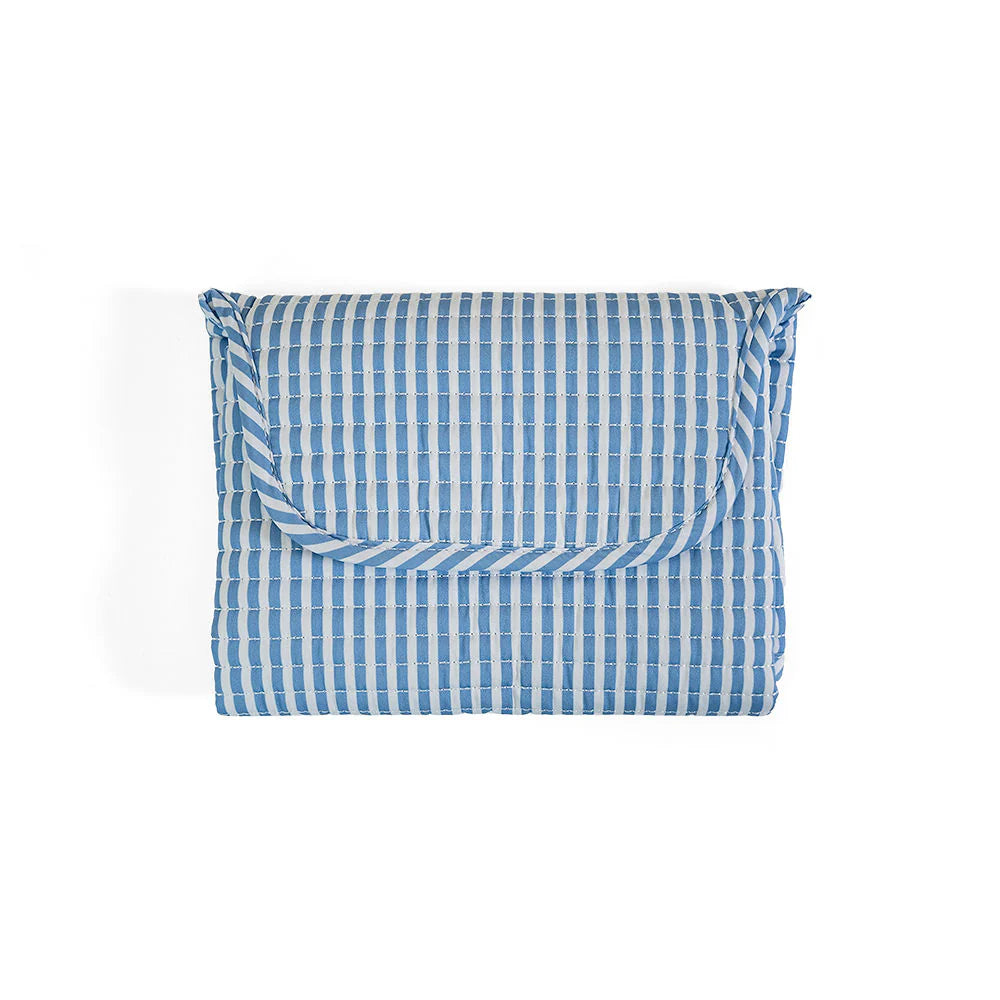 Soft quilted changing mat by TRVL Designs with padded surface and secure edges for comfortable diaper changes.