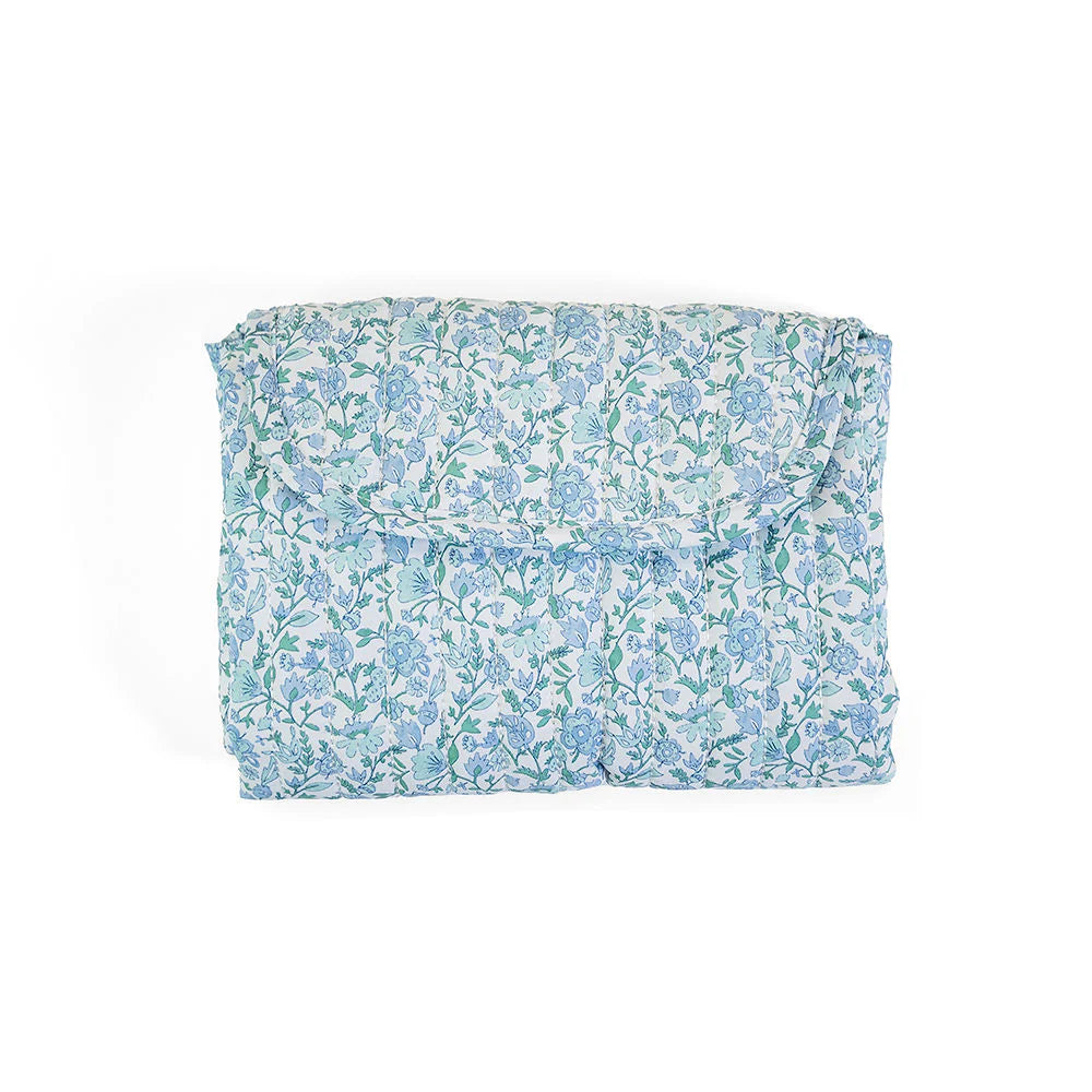Soft quilted changing mat by TRVL Designs with padded surface and secure edges for comfortable baby diaper changes.