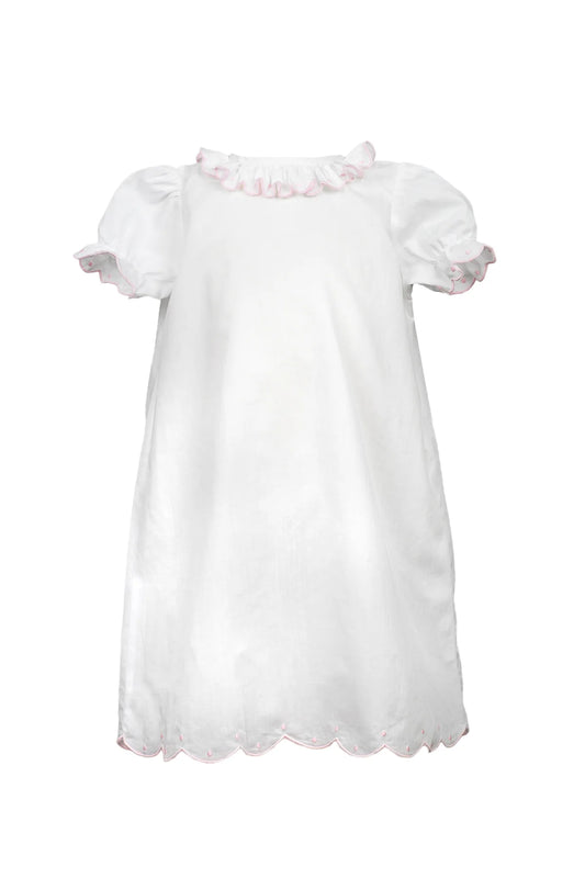 The Proper Peony Ruthie scalloped ruffle gown featuring delicate scalloped edges and flowing fabric, perfect for elegant daytime wear.