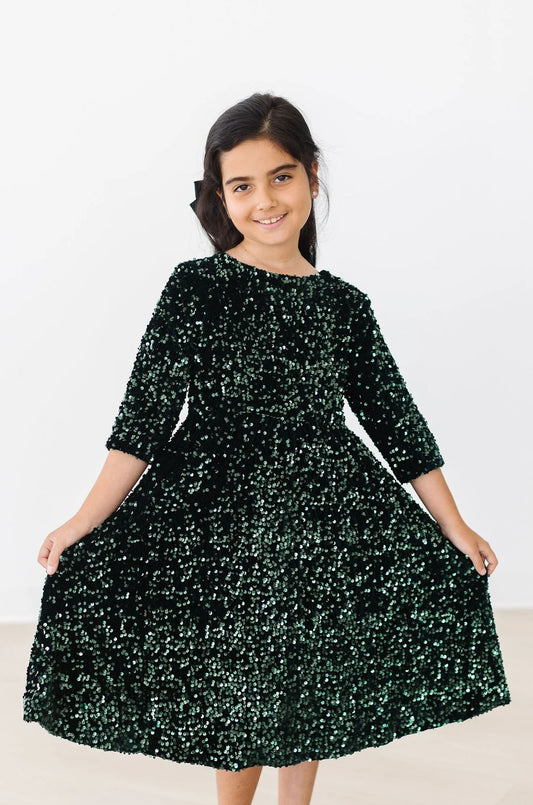 Hunter green velvet sequin dress by Mila & Rose, featuring a stylish design with shimmering sequins and elegant velvet fabric.