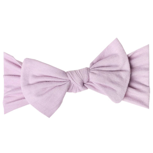 Copper Pearl Lily knit headband with a bow, soft and stretchy baby accessory in a cozy knit design.