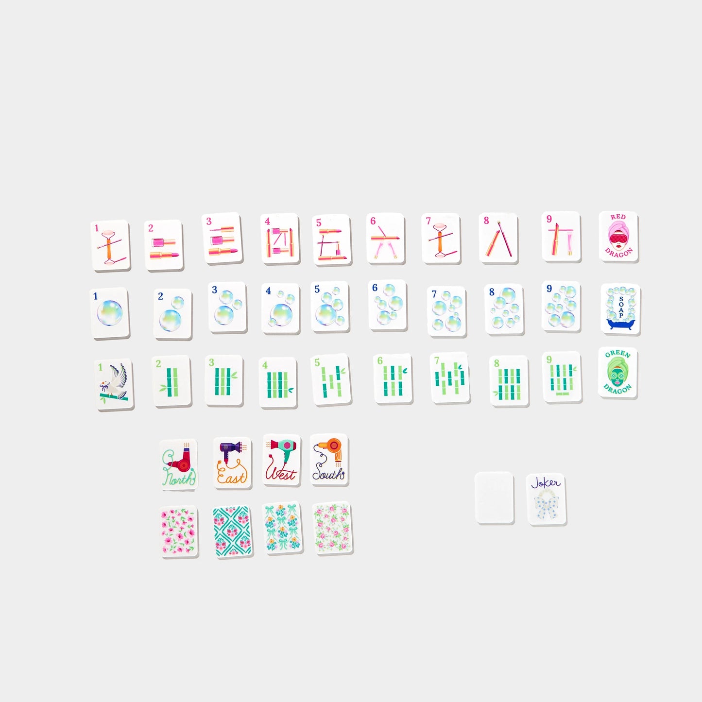 Mini Mahjer Complete Game Bubbles & Bows Edition box with colorful game pieces and vibrant packaging.