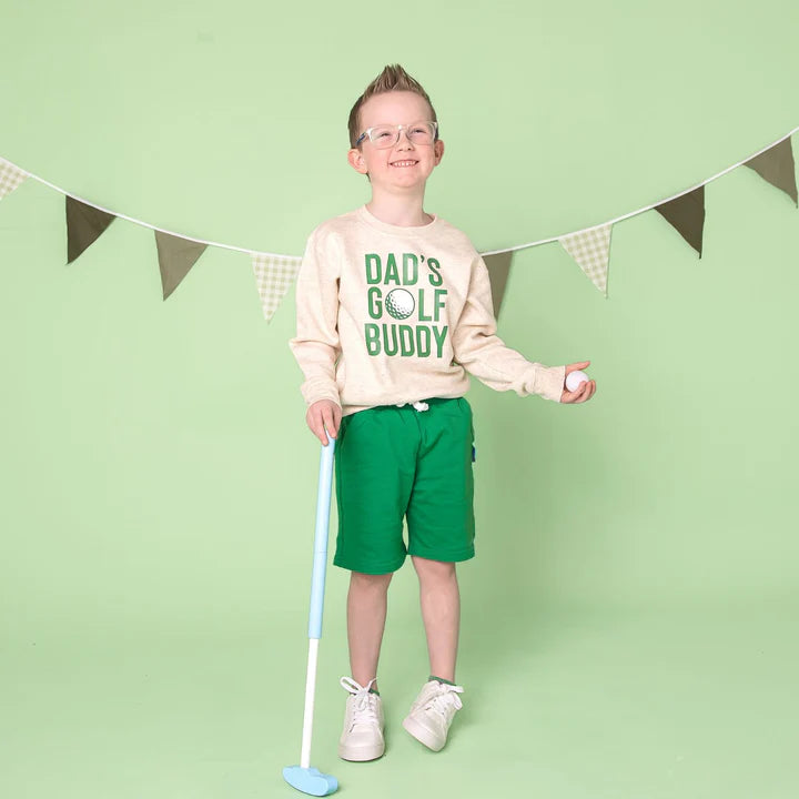 Model wearing the Dad's Golf Buddy sweatshirt by Sweet Wink, featuring a casual fit and golf-themed design.