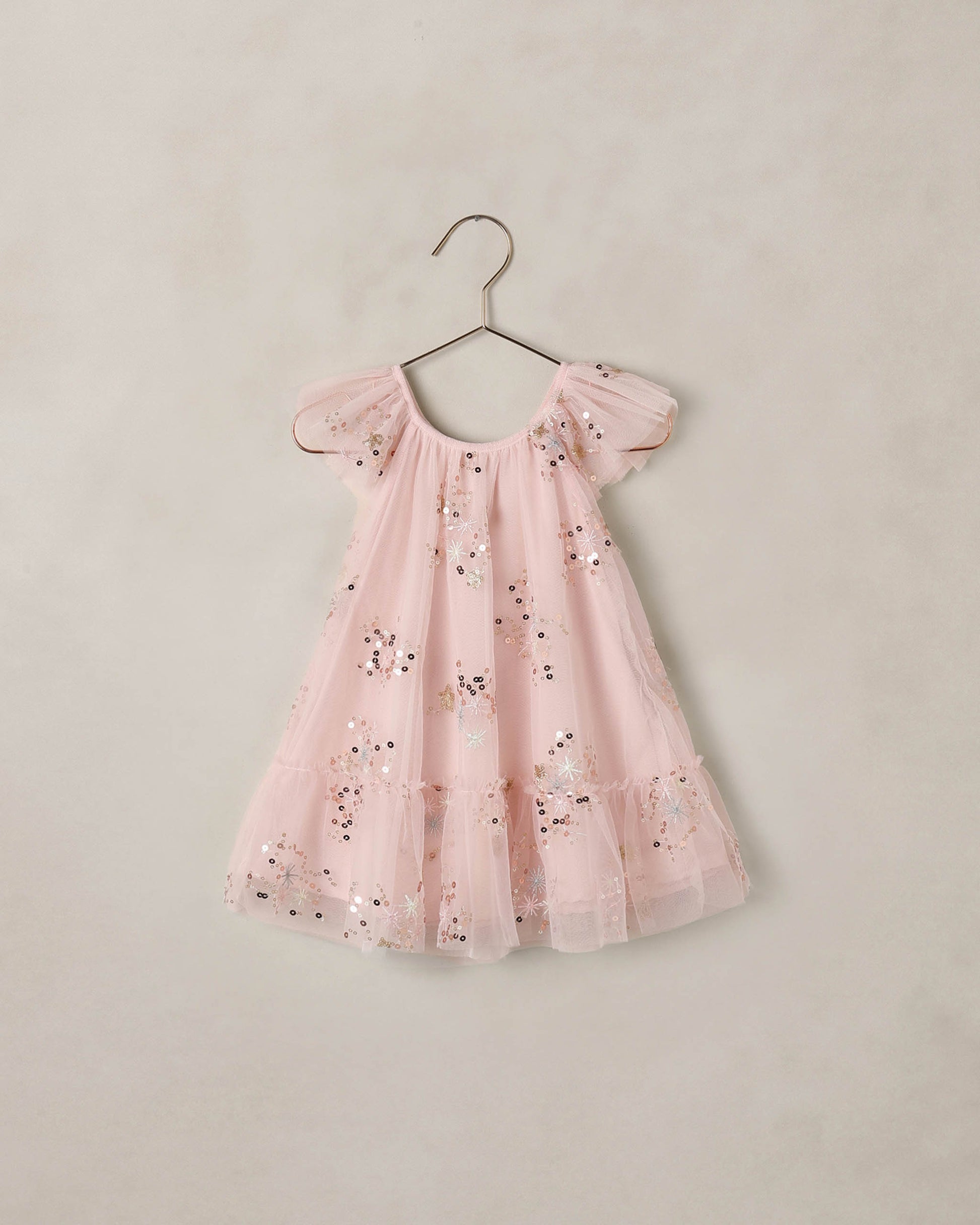 Pink Edie dress by Noralee, featuring a flowy silhouette and delicate fabric, shown on a model in this stylish fashion image.