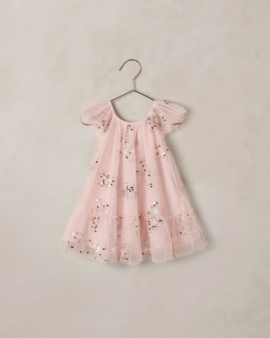 Pink Edie dress by Noralee, featuring a flowy silhouette and delicate fabric, shown on a model in this stylish fashion image.
