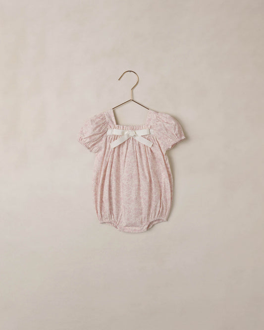 Ivory lavender floral Lyla romper by Noralee featuring a sleeveless design and floral print, displayed on a hanger.