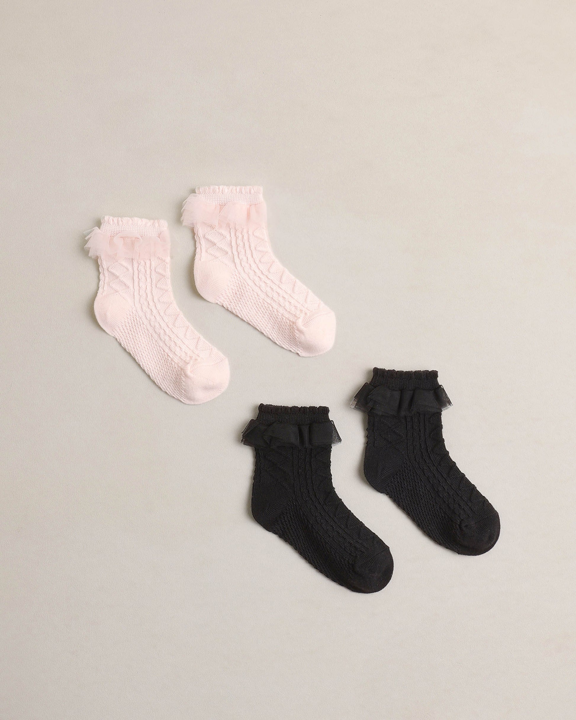 Black and blush ruffle socks by Noralee featuring soft fabric and decorative ruffles, perfect for stylish everyday wear.