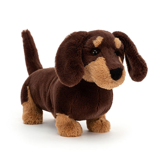 Jellycat Otto Sausage Dog plush toy with soft brown fur and floppy ears, sitting upright on a white background.