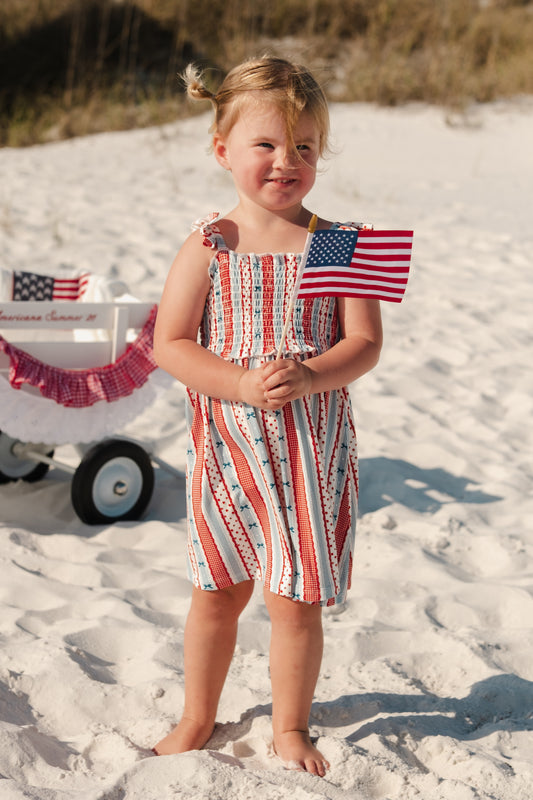 In My Jammers Heritage Striped Smocked Twirl Dress featuring colorful stripes and a gathered smocked bodice, perfect for girls' casual wear.