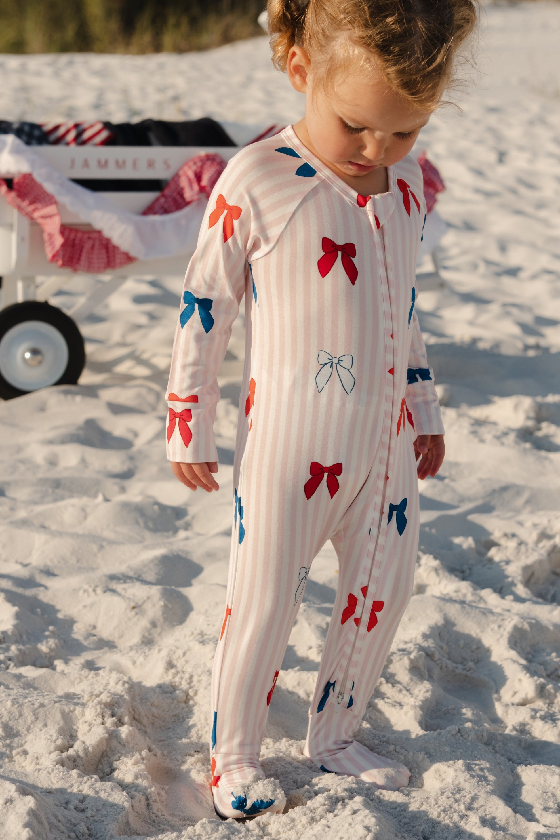 In My Jammers Liberty Bow Zipper Romper featuring a front zipper, bow accents, and colorful fabric for a playful, casual look.