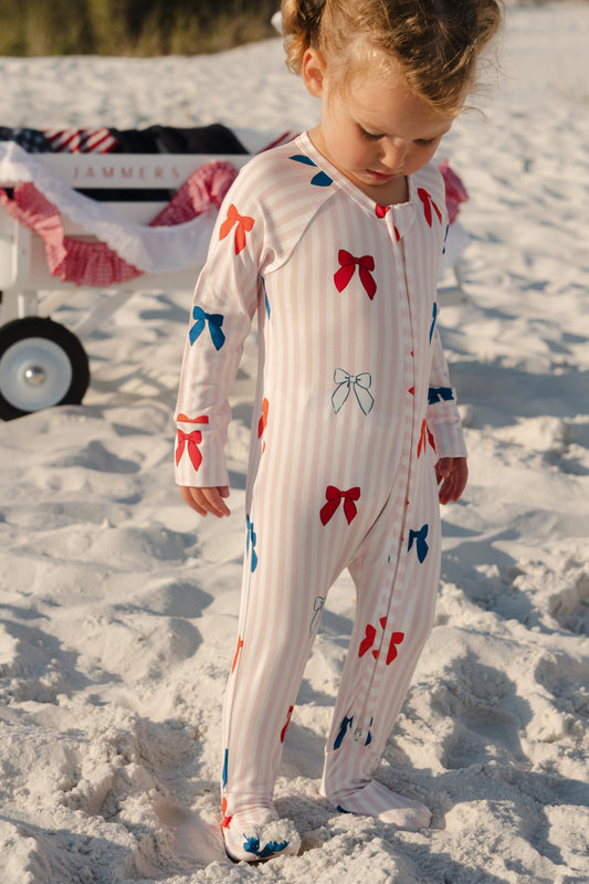 In My Jammers Liberty Bow Zipper Romper featuring a front zipper, bow accents, and colorful fabric for a playful, casual look.