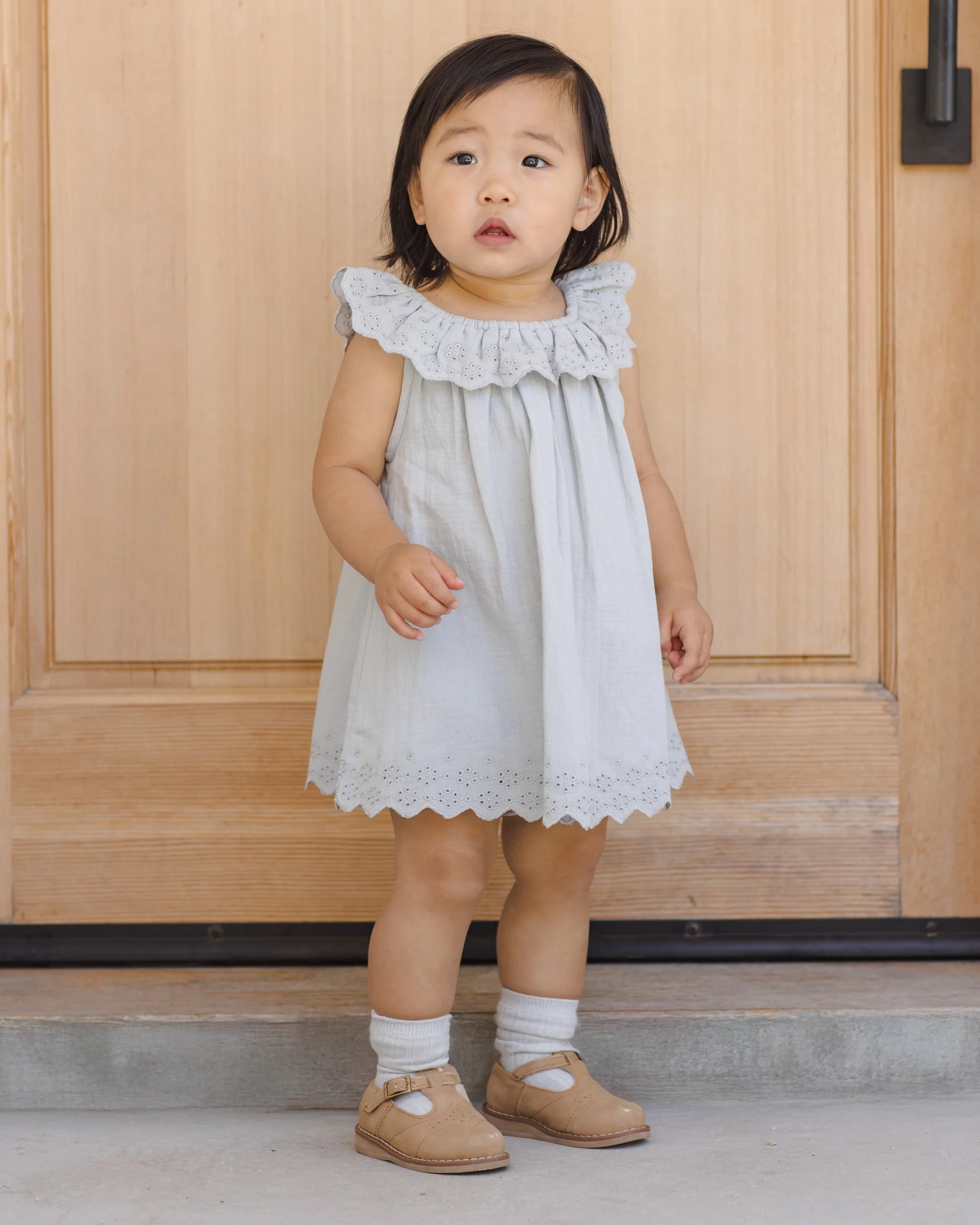 Quincy Mae Sky Isla Dress shown on a child, featuring a soft pastel color, lightweight fabric, and playful design in a lifestyle setting.