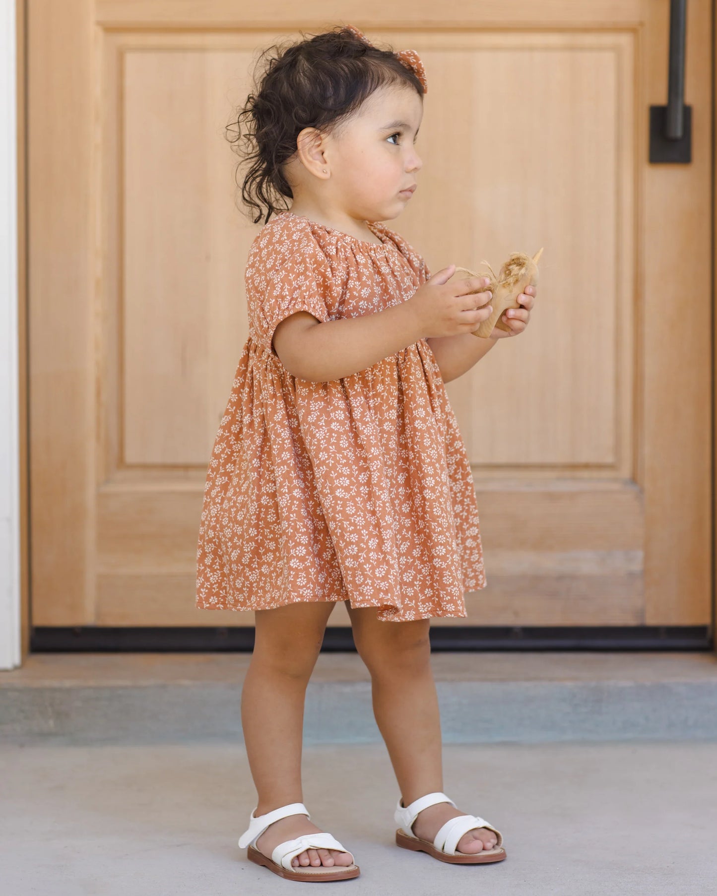 Quincy Mae Poppy Floral Bella Dress for girls, featuring a colorful floral pattern and comfortable fabric, shown in a lifestyle setting.