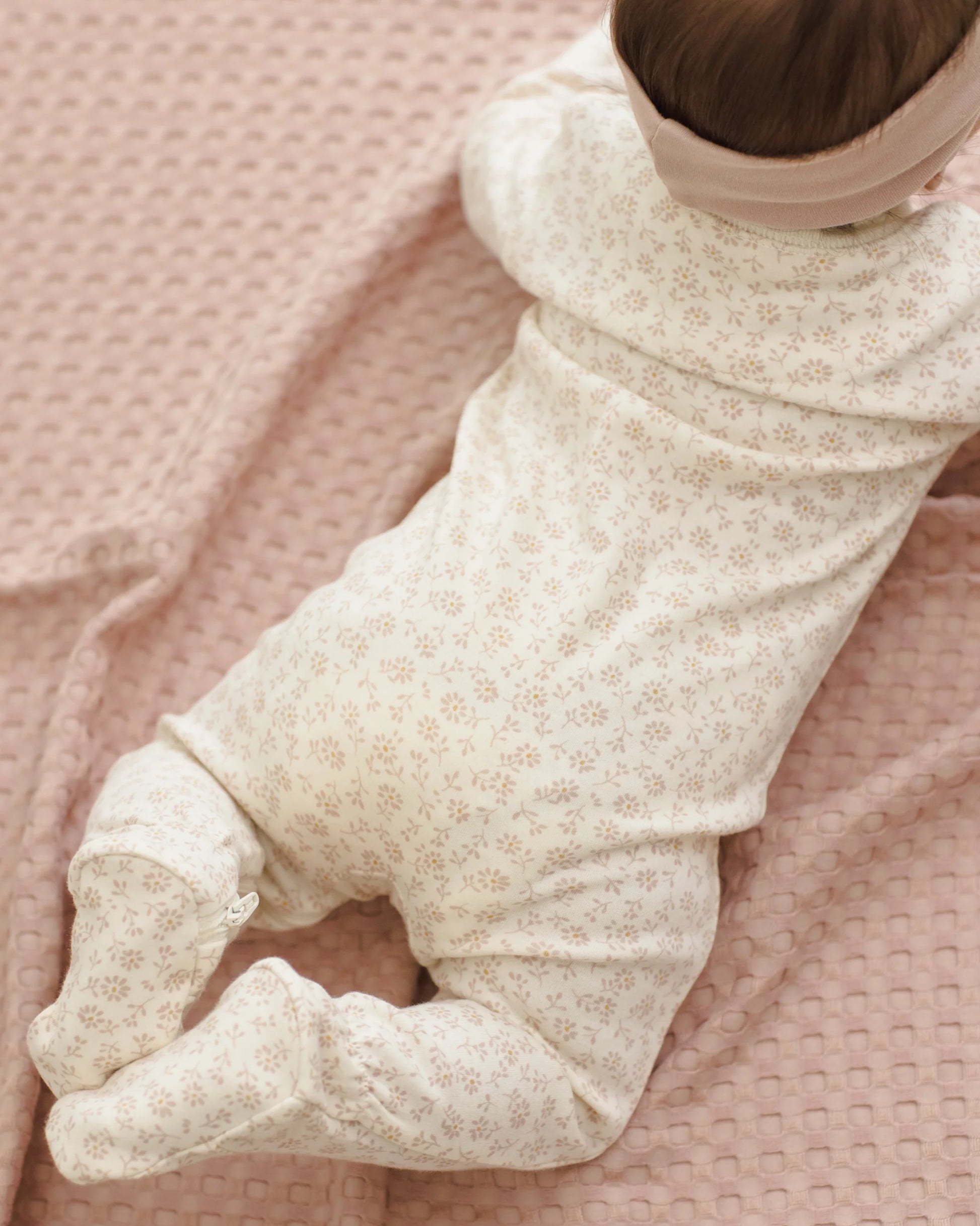 Quincy Mae Ditsy Zip Long Sleeve Sleeper Footie in soft fabric with a floral pattern, featuring a front zipper and long sleeves.