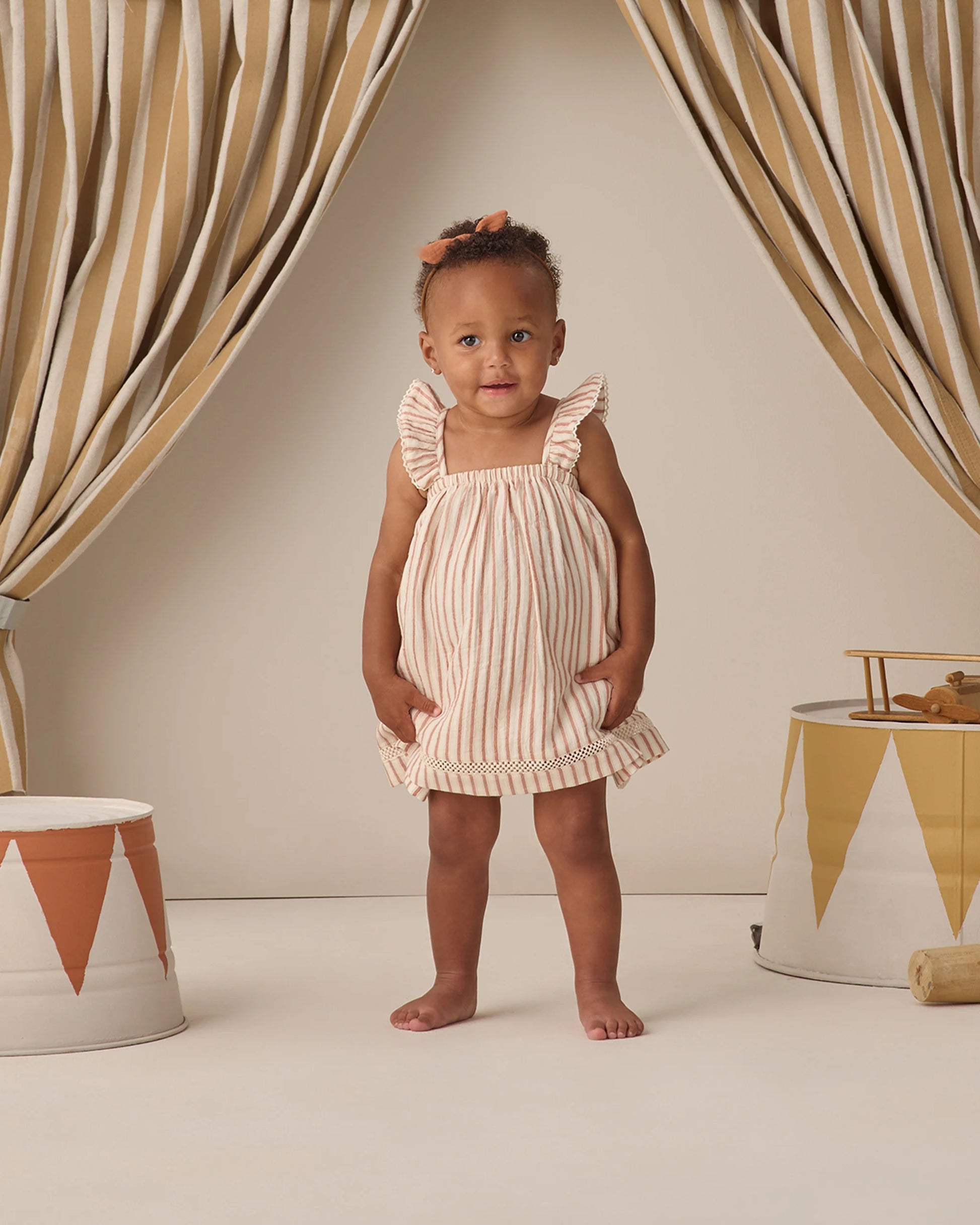 Vintage stripe ruffle tank dress by Quincy Mae featuring a sleeveless design with ruffled edges and a classic striped pattern.